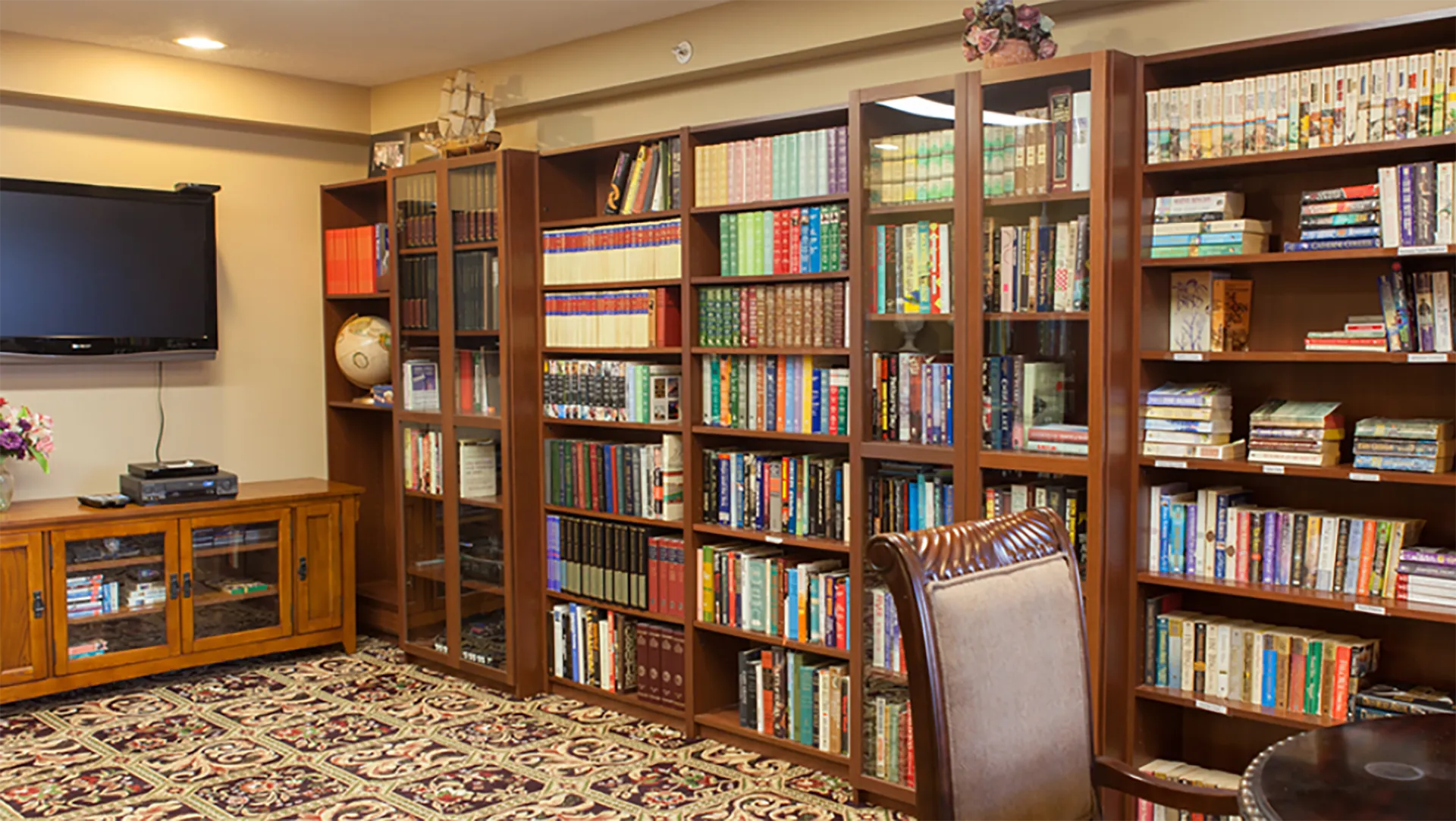 a full bookshelf in the library at the Renaissance Retirement Residence in Victoria, BC